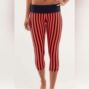 Lululemon orange/black stripe black waistband capri leggings. Size 4.